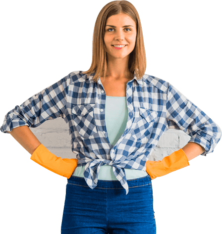 Smiling woman in a plaid shirt and yellow gloves stands confidently.
