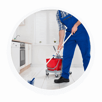 Person mopping kitchen floor with cleaning supplies.