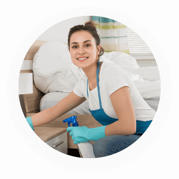Woman cleaning a room with spray bottle.